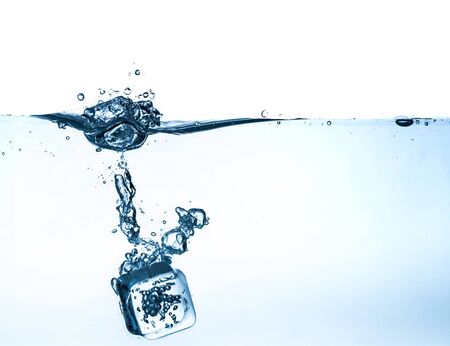 Ice Cube Falling into Waterの写真素材