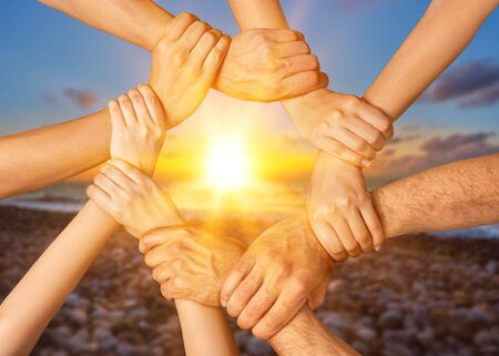 Family holding their hands together in shape on background
