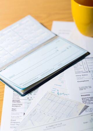 Tax Documents with Checkbook and Cupの写真素材