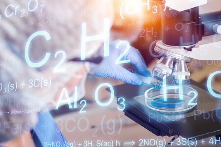 Pipette dropping a sample into a test pad,  Medical doctor or scientist with microscope, equipment and science experiments , glassware containing chemical liquid, researching samples in laboratoryの写真素材