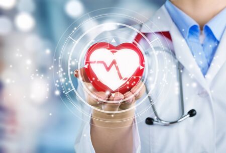 Doctor on blurred background holding heartbeatの写真素材