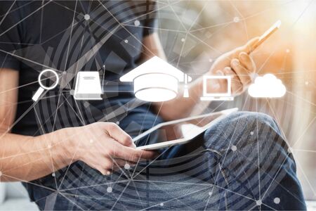 Online education, e-learning and e-book concept. a man using digital tablet for education, with education and online learning media iconsの写真素材