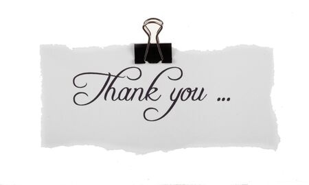 Thank you note held up with a binder clipの写真素材