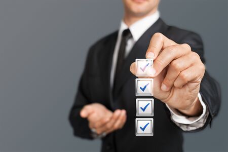 Checklist concept, Businessman checking mark on the check boxes with marker red