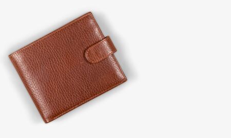 Top view of New black genuine leather wallet with banknotes and credit card inside isolated on white...
