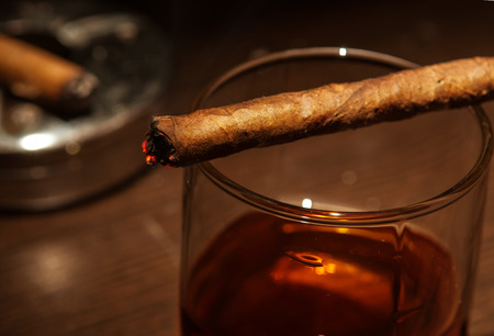 Luxury whiskey glass with cigarの写真素材