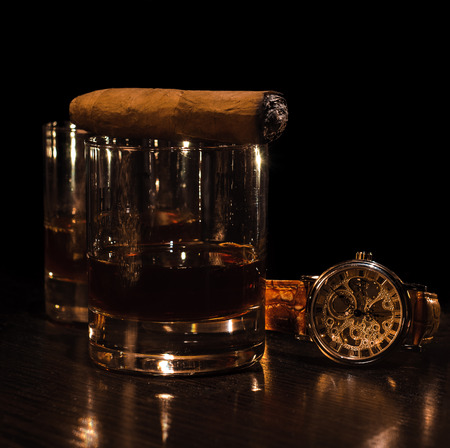Still life with cognac, cigar , and a watch on a wooden background. Luxuryの写真素材