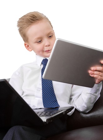 Multitask serious Young Businessman  boy in suit working on tabletの写真素材