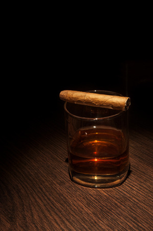 Luxury whiskey glass with cigar. Close up shotの写真素材