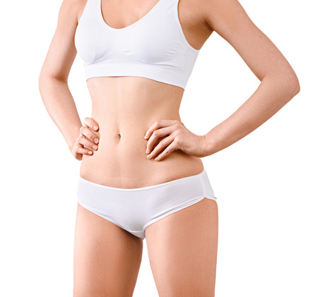 Woman with perfect slim body posing in underwear on the white background isolated. Healthcare, bodycare concept without faceの写真素材