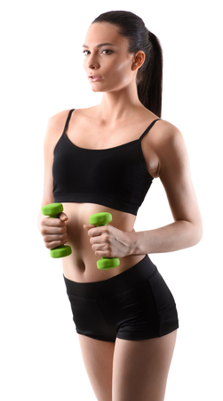 Fitness woman working out with green dumbbell on isolated white backgroundの写真素材