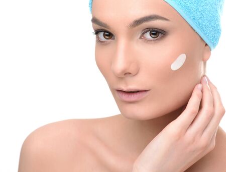 Spa care woman with perfect skin wearing hair towel after beauty treatment. Isolated on white background. Health care conceptの写真素材
