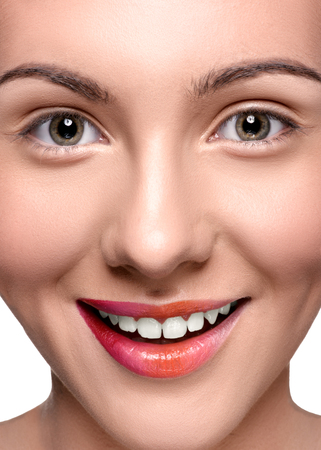 Smiling happy woman with colorful lips make up looking at the camera. Close up head shotの写真素材