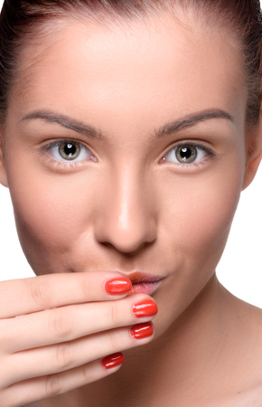 Beautiful young woman with colorful lips makeup and red nails looking at the camera. Close up head shotの写真素材