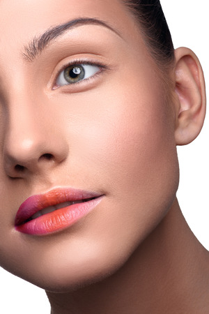 Half face of beautiful, young woman with pure skin with colorful lips makeup. Close up head shotの写真素材