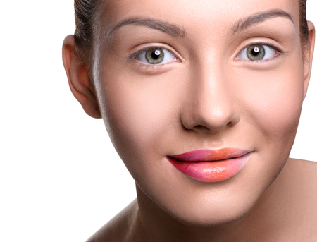 Close up head shot of beautiful young woman with colorful lips makeup on isolated white looking at the cameraの写真素材