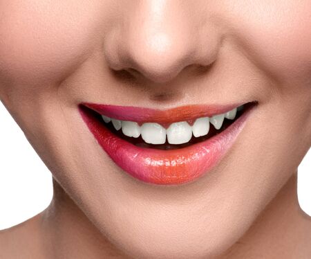Smiling happy woman with colorful lips make up looking at the camera. Close up lips shotの写真素材