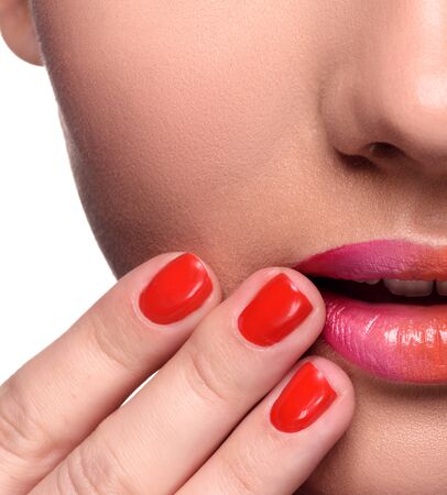 Part of face. Sensual young woman with colorful lips makeup and red nails. Close up head shotの写真素材