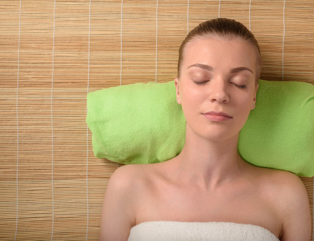 Beautiful young woman getting relaxing head massage in the spa salon. Top view high resolution shot. Model with closed eyesの写真素材