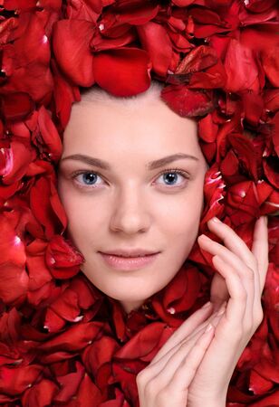 Sensual. beautiful woman lying in petal of roses. Top viewの写真素材