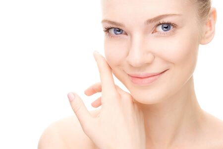 Young beauty woman portrait.  Girl Touching her Face. Studio shot. Isolate on white. Health Care, cosmetic concept. Blank for commercial advertisingの写真素材