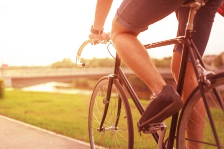 Hipster on bike in the city at sunset. Without faceの写真素材