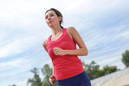 Dynamic close up shot of jogging man on the stadium. Horizontalの写真素材