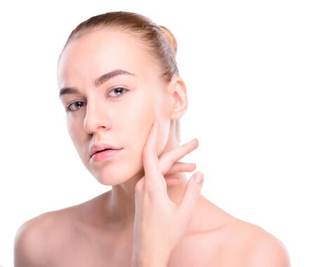 Beauty of health young woman. Girl Touching her Face. Isolate on white backgroundの写真素材