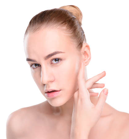 Beauty of health young woman. Girl Touching her Face. Isolate on white backgroundの写真素材