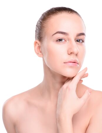 Beauty of health young woman. Girl Touching her Face. Isolate on white backgroundの写真素材