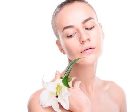 Beauty of health young woman with lily. Isolate on white backgroundの写真素材