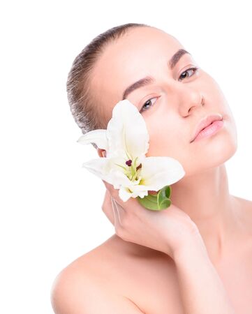 Beauty young woman posing with lily. Isolate on white backgroundの写真素材