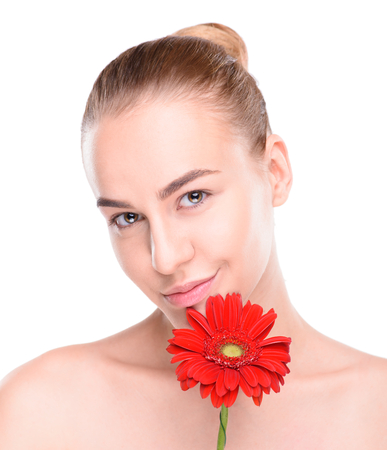 Beautiful woman with red gerbera. Isolated on white background.の写真素材