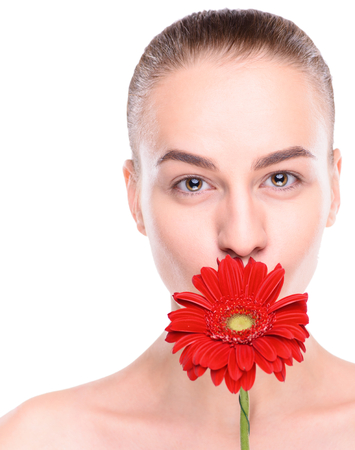 Cheerful beautiful woman with red gerbera. Isolated on white background.の写真素材
