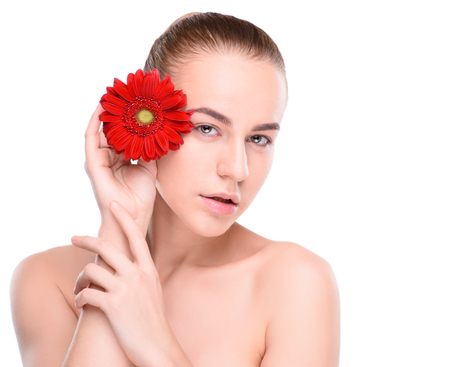 Beautiful woman with red gerbera. Isolated on white background.の写真素材