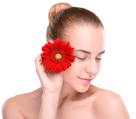 Beautiful woman with red gerbera. Isolated on white background.の写真素材