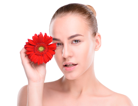 Woman posing with red gerbera. Isolated on white background.の写真素材