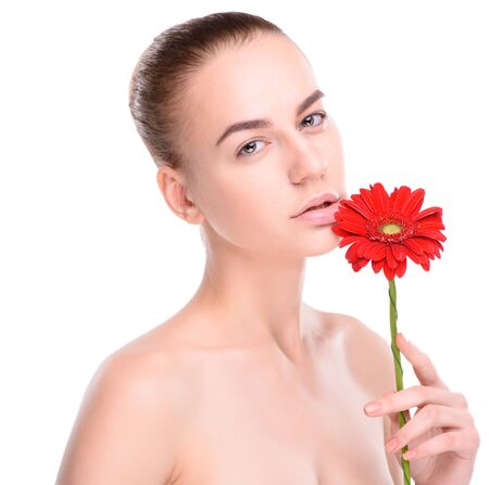 Beautiful woman with red gerbera. Isolated on white background.の写真素材