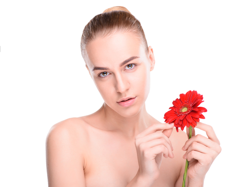 Woman posing with red gerbera. Isolated on white background.の写真素材