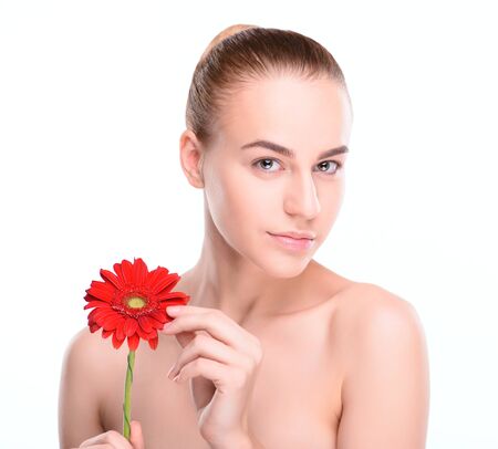 Beautiful woman with red gerbera. Isolated on white background.の写真素材