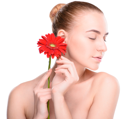 Beautiful woman with red gerbera. Isolated on white background.の写真素材
