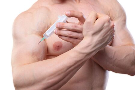 Close up shot an injection of steroids in biceps. Shot without faceの写真素材