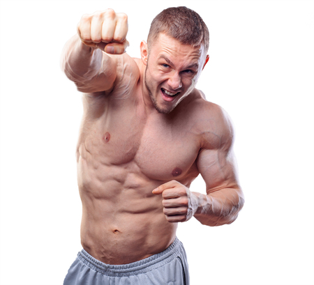 Male boxer making training punches on grey background. Model looking at the sideの写真素材