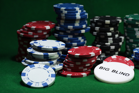 Close up shot of group poker chips on green table.の写真素材