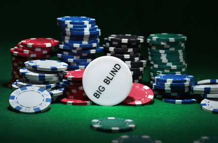 Close up shot of group poker chips on green table.の写真素材