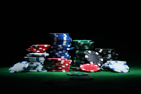 Close up shot of group poker chips on green table. Front viewの写真素材