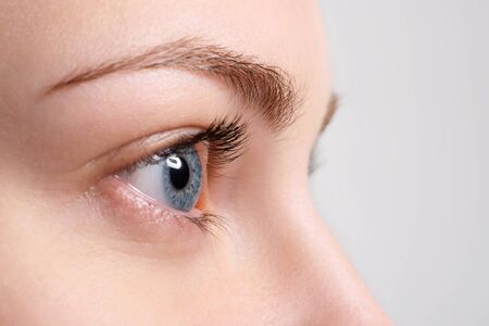 Close up blue eye with natural makeup looking at the side, macro shot with perfect skinの写真素材