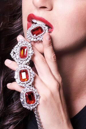 Macro shot. Red lips with jewelery pendant.の写真素材