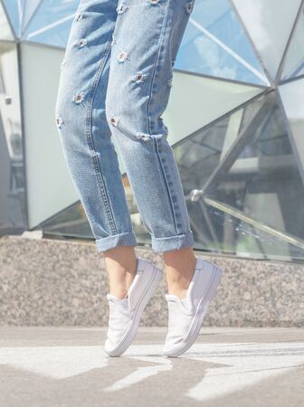 Woman posing. Summer look. White sneakers shoesの写真素材