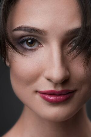 Close up portrait of young smiling woman. Red lipsの写真素材